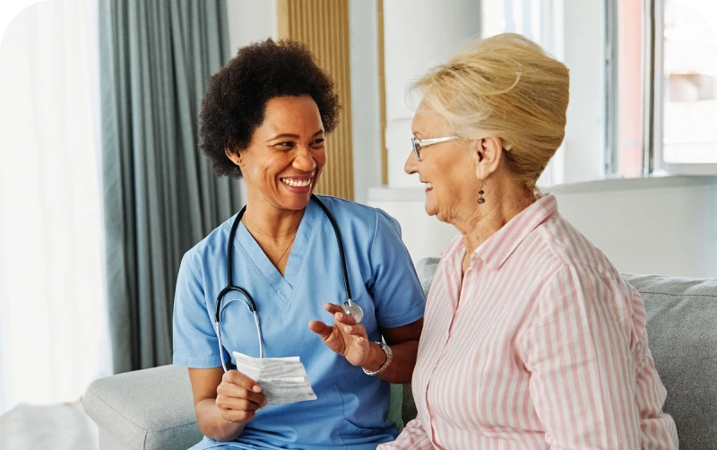 Healthcare professional providing supportive care to an older woman