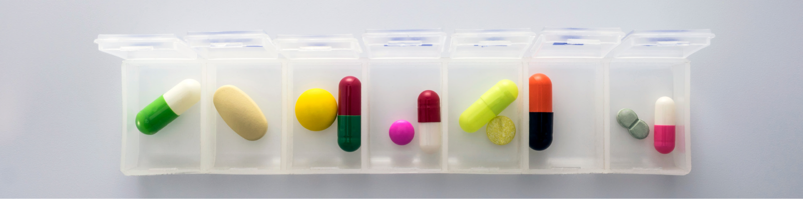 Pill organizer with various colored pills for daily medication
