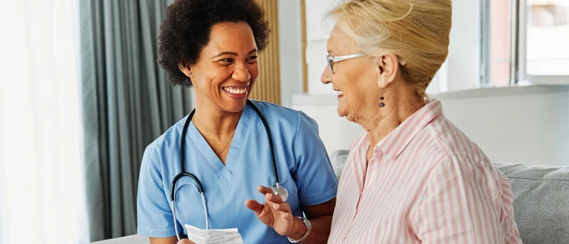 Healthcare professional providing supportive care to an older woman