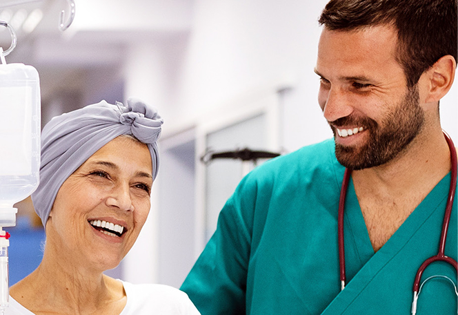 A healthcare professional assists a patient in a hospital setting, both wearing medical attire