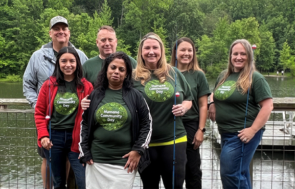 Humana staff with fishing rods at an annual youth fishing event