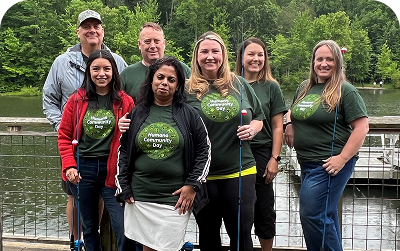 Humana staff with fishing rods at an annual youth fishing event