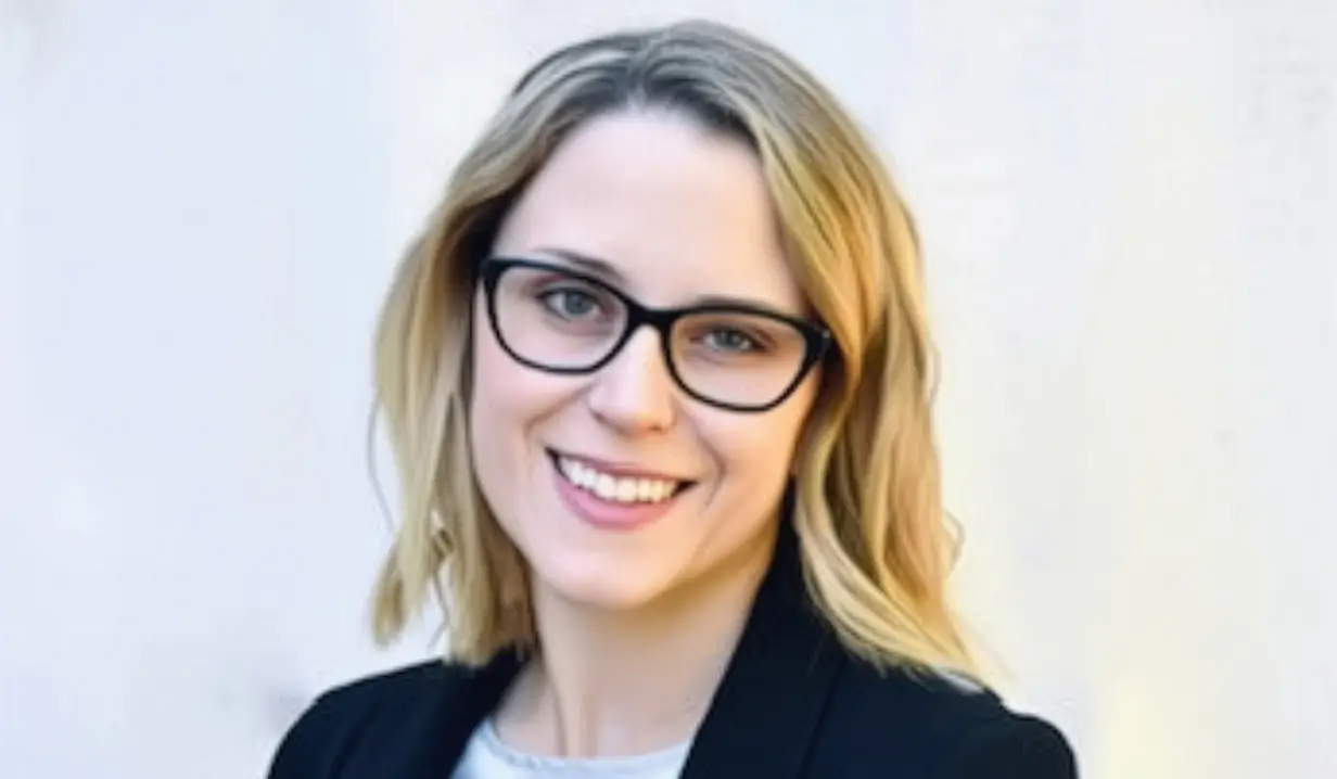 Jessica Topolski smiling while wearing specs