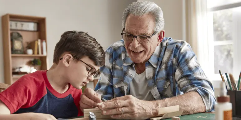 A grandfather guiding to his grandchild