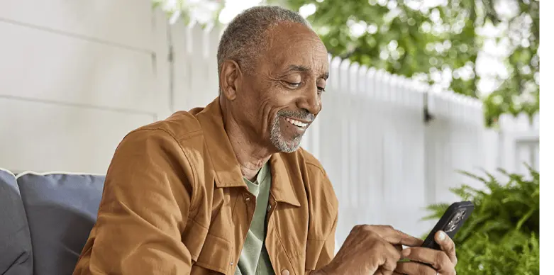 A old man looking at his mobile phone