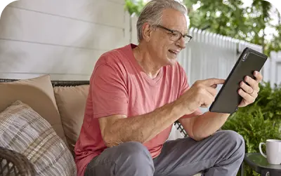 A old man looking at his ipad
