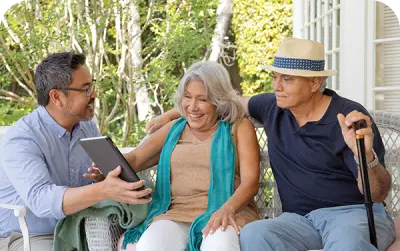 A consultant showing screen to old couple