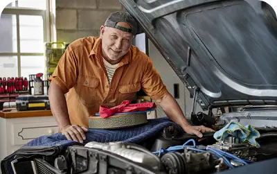 A man checking the issue in car bonnet