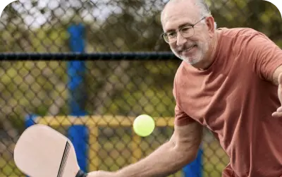 A old man playing badminton