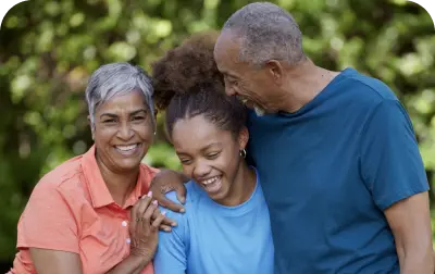 A couple with a girl are smiling